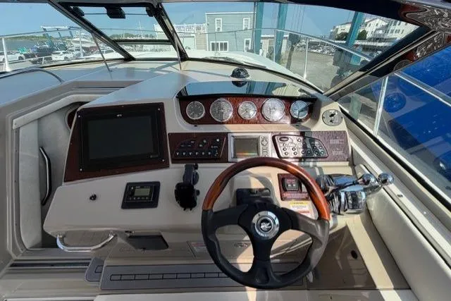Slide: The Image of Cockpit of 2008 Sea Ray Sundancer 350 with steering wheel and control panel. - 16