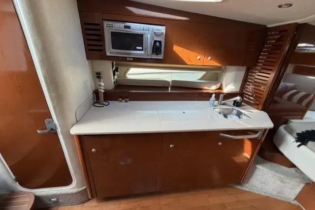 Slide: The Image of Interior of 2008 Sea Ray Sundancer 350 yacht kitchen with microwave and sink. - 23