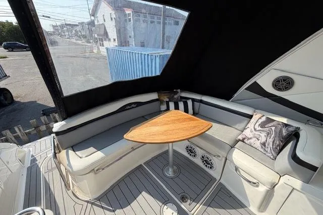 Slide: The Image of 2008 Sea Ray Sundancer 350 interior with cushioned seating and wooden table. - 5