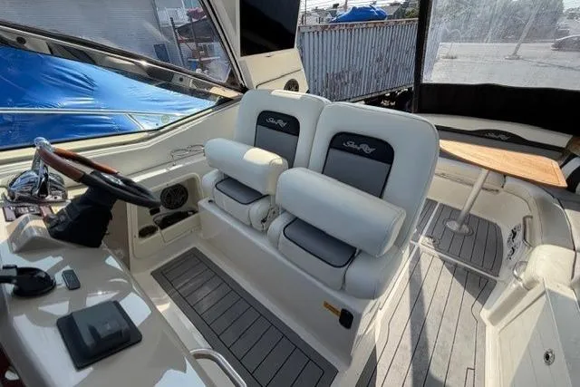 Slide: The Image of 2008 Sea Ray Sundancer 350 cockpit with dual seats and steering wheel, showcasing luxury design. - 14