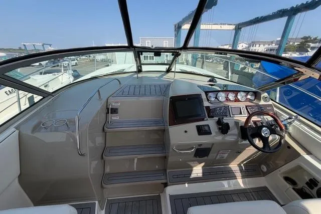 Slide: The Image of 2008 Sea Ray Sundancer 350 cockpit with modern controls and spacious seating. - 18