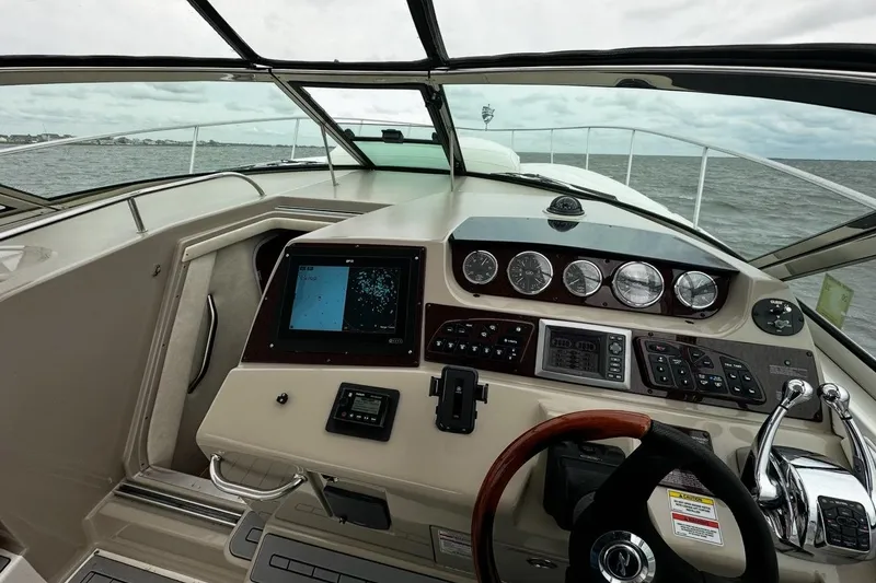 Slide: The Image of 2008 Sea Ray 350 Sundancer helm with navigation controls and ocean view. - 6