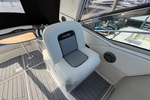Slide: The Image of 2008 Sea Ray Sundancer 350 interior with cushioned seating and wooden table. - 12