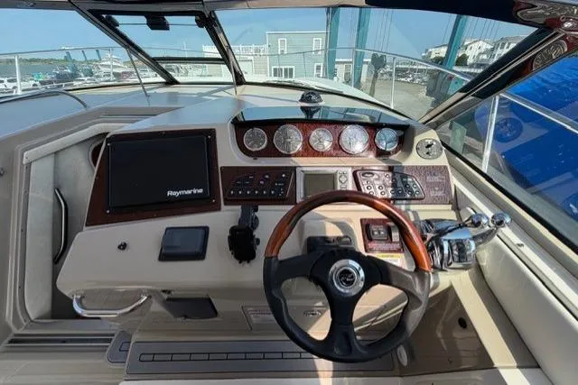 Slide: The Image of 2008 Sea Ray Sundancer 350 helm with steering wheel and navigation controls. - 15