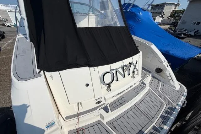 Slide: The Image of 2008 Sea Ray Sundancer 350 boat named "Onyx" docked with covered cockpit. - 3