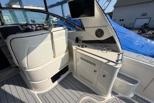 Slide: The Image of 2008 Sea Ray Sundancer 350 interior with helm, sink, and storage cabinets. - 6
