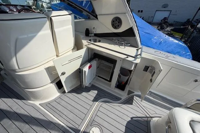 Slide: The Image of 2008 Sea Ray Sundancer 350 yacht interior with open cabinets and mini fridge. - 7