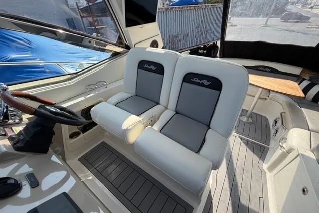Slide: The Image of 2008 Sea Ray Sundancer 350 cockpit with dual seats and wooden accents. - 13