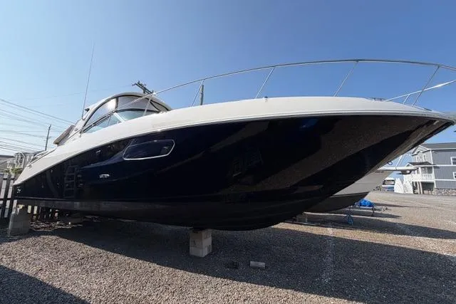 Slide: The Image of 2008 Sea Ray Sundancer 350 yacht on dry dock, showcasing sleek design and modern features. - 1
