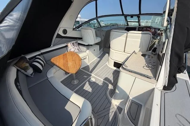 Slide: The Image of Interior of 2008 Sea Ray Sundancer 350 yacht with elegant seating and wooden table. - 4
