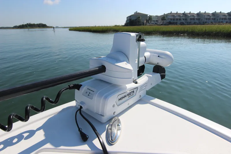 Slide: The Image of 2021 Sportsman Masters 267OE Bay Boat with Minn Kota motor on calm water. - 13