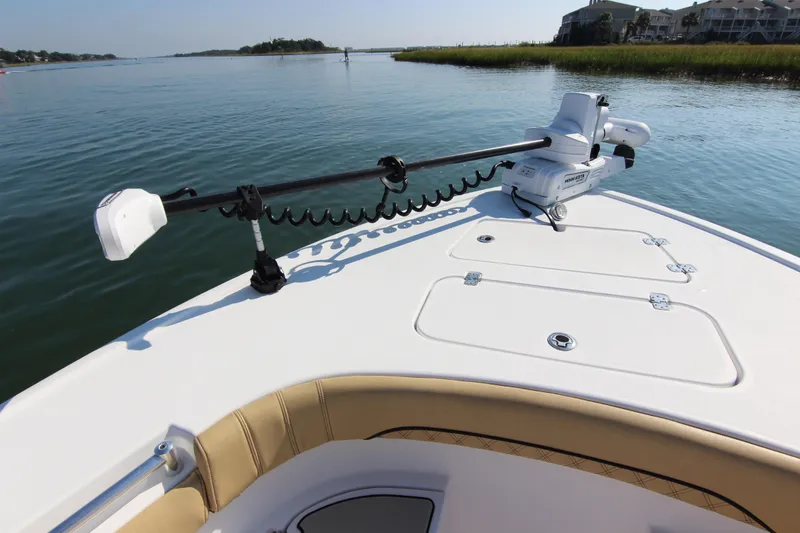 Slide: The Image of 2021 Sportsman Masters 267OE Bay Boat on calm water, featuring a trolling motor. - 14