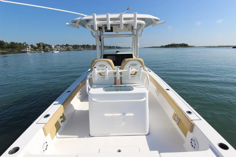 Slide: The Image of 2021 Sportsman Masters 267OE Bay Boat on calm water, showcasing spacious deck and seating. - 19