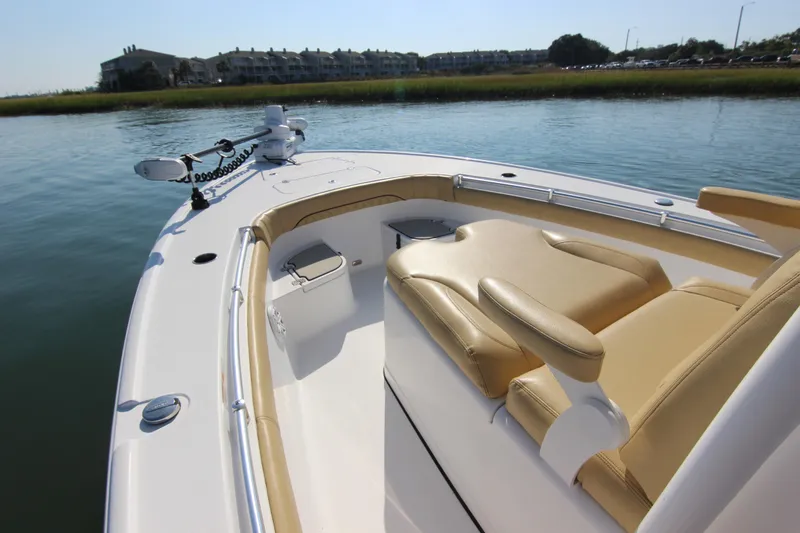 Slide: The Image of 2021 Sportsman Masters 267OE Bay Boat with tan seating, docked on calm water. - 21