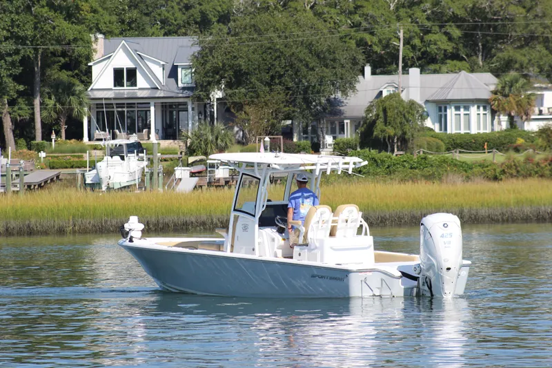 Slide: The Image of 2021 Sportsman Masters 267OE Bay Boat cruising near waterfront homes. - 3