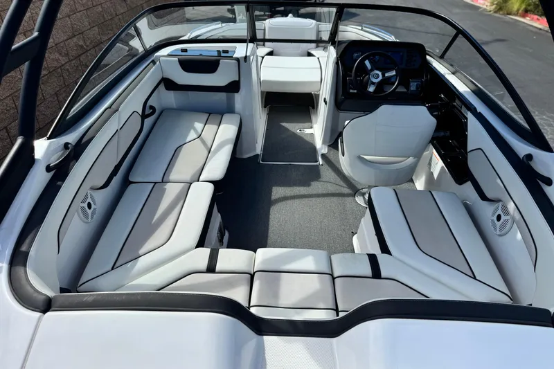Slide: The Image of 2019 Yamaha Boats AR210 interior with sleek seating and modern dashboard design. - 13