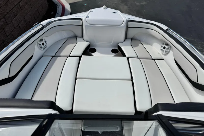 Slide: The Image of 2019 Yamaha AR210 boat interior with cushioned seating and built-in speakers. - 14
