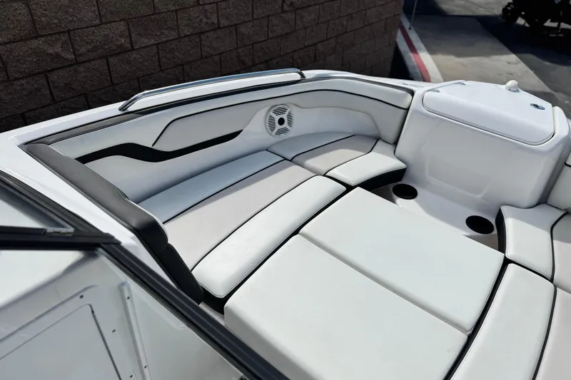Slide: The Image of 2019 Yamaha AR210 boat interior with white cushioned seating and speaker. - 15