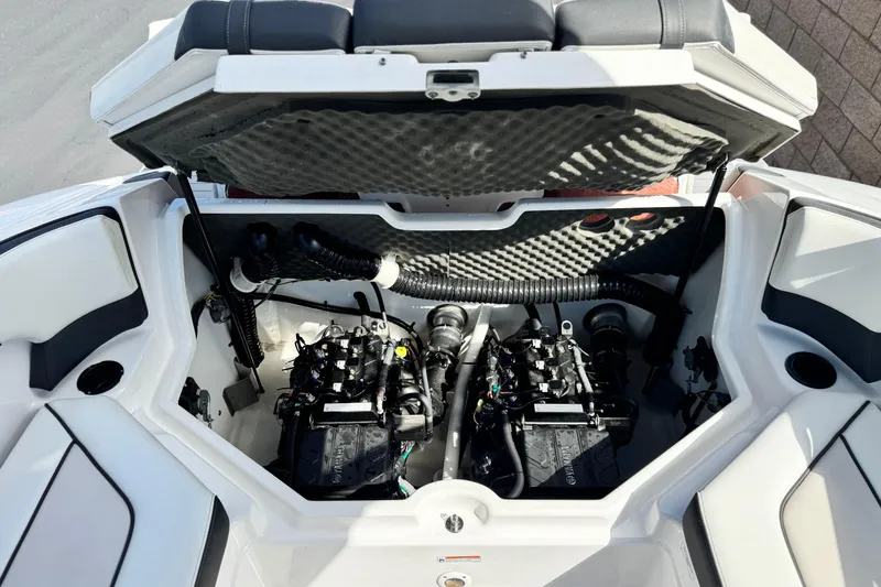 Slide: The Image of 2019 Yamaha AR210 boat engine compartment with dual engines and open hatch. - 19