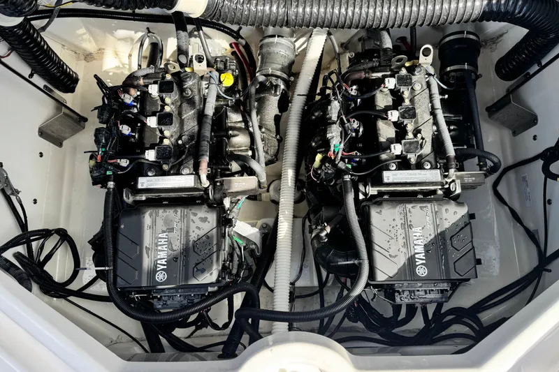 Slide: The Image of Twin engines of a 2019 Yamaha Boats AR210, showcasing intricate wiring and components. - 20