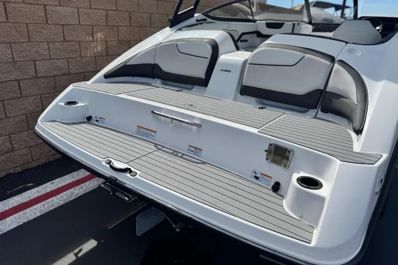 Slide: The Image of 2019 Yamaha AR210 boat rear view with seating and swim platform. - 6