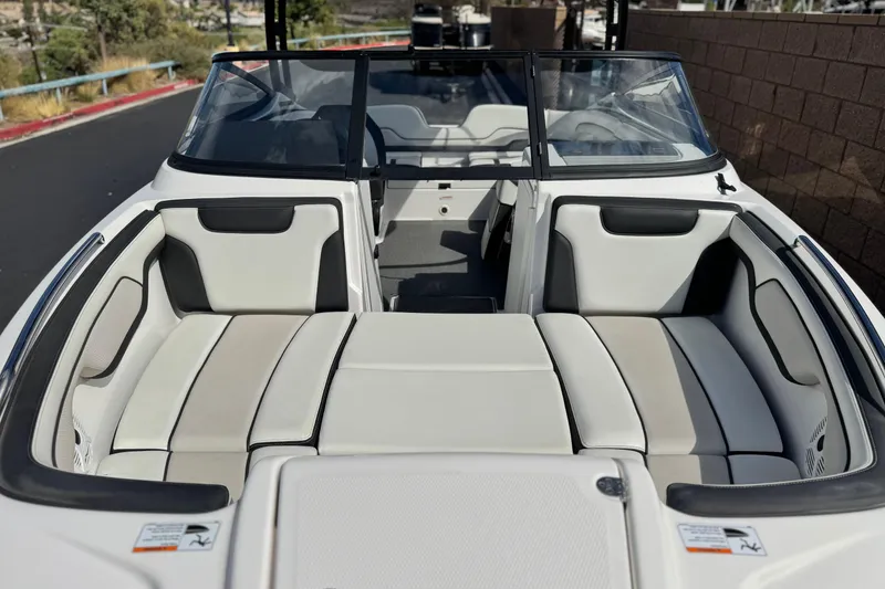 Slide: The Image of 2019 Yamaha Boats AR210 interior with spacious seating and sleek design. - 9