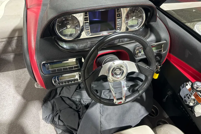 Slide: The Image of 2009 Malibu Wakesetter 23 LSV dashboard with steering wheel and instrument panel. - 11