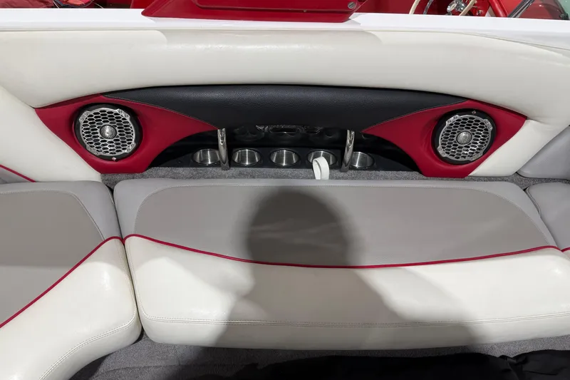 Slide: The Image of 2009 Malibu Wakesetter 23 LSV interior with red accents and built-in speakers. - 13