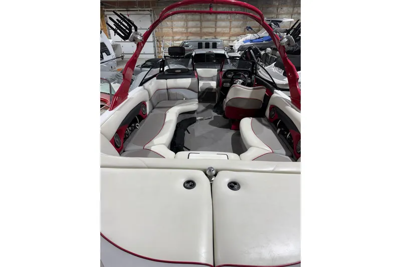 Slide: The Image of 2009 Malibu Wakesetter 23 LSV interior with red accents and spacious seating. - 17
