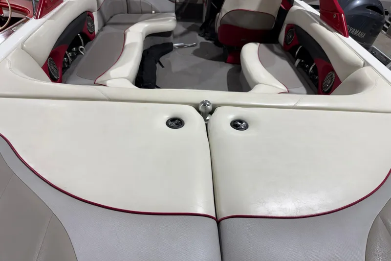 Slide: The Image of 2009 Malibu Wakesetter 23 LSV interior with white and red seating, featuring built-in speakers. - 19