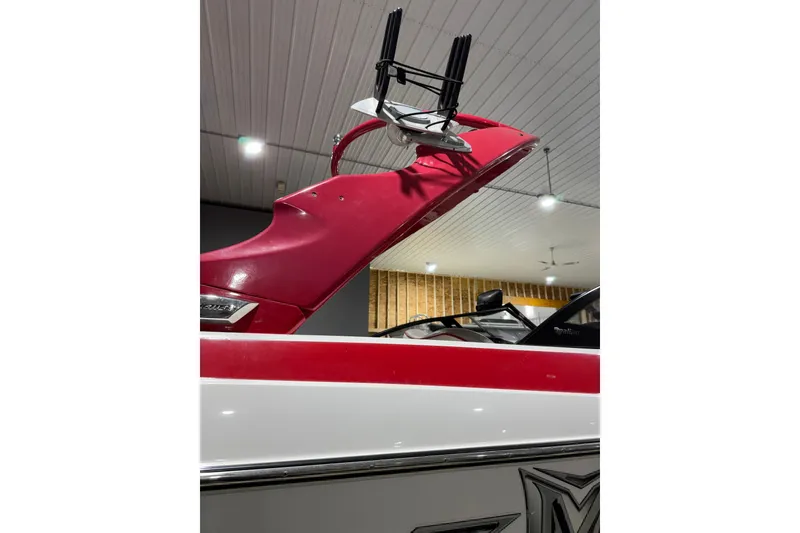 Slide: The Image of 2009 Malibu Wakesetter 23 LSV boat with red and white detailing in a garage. - 25
