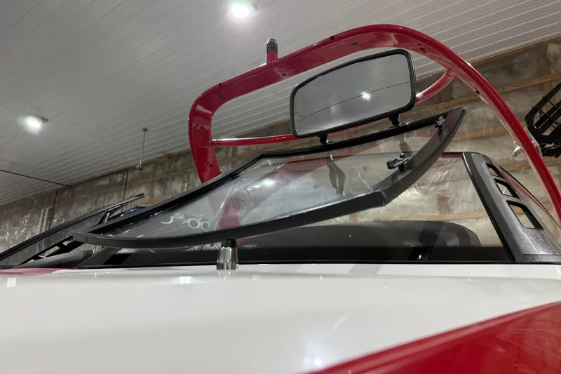 Slide: The Image of 2009 Malibu Wakesetter 23 LSV boat windshield and red tower in a garage. - 27