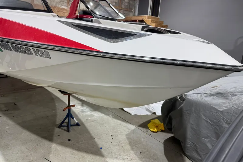 Slide: The Image of 2009 Malibu Wakesetter 23 LSV boat in garage, red and white design. - 31