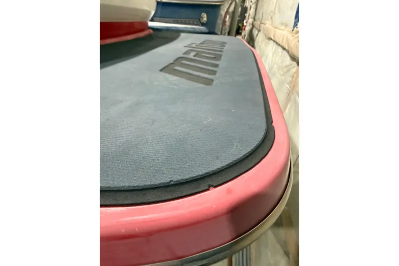 Slide: The Image of 2009 Malibu Wakesetter 23 LSV boat deck with logo, featuring red and gray colors. - 35