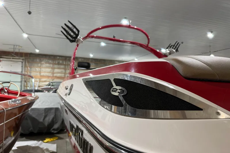 Slide: The Image of 2009 Malibu Wakesetter 23 LSV boat in indoor storage, showcasing sleek design and detailing. - 39