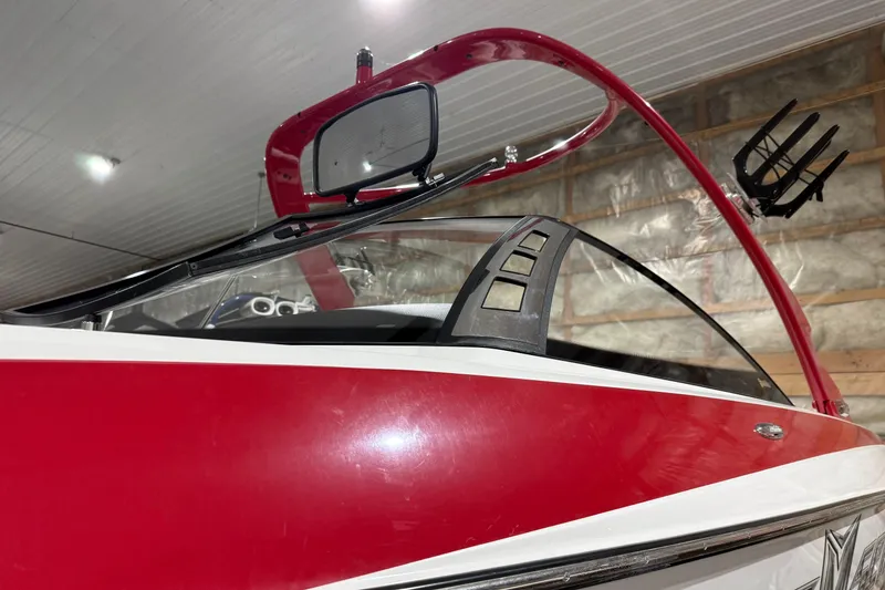 Slide: The Image of Red 2009 Malibu Wakesetter 23 LSV boat in indoor storage, showcasing sleek design. - 40
