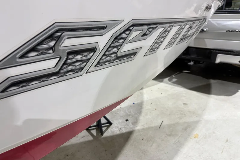 Slide: The Image of Close-up of 2009 Malibu Wakesetter 23 LSV boat logo in a garage setting. - 45
