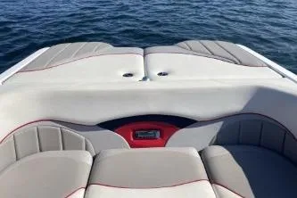 Slide: The Image of 2009 Malibu Wakesetter 23 LSV boat interior with cushioned seating on open water. - 5