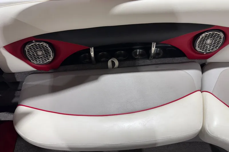 Slide: The Image of 2009 Malibu Wakesetter 23 LSV interior with speakers and cup holders, featuring red and white upholstery. - 8