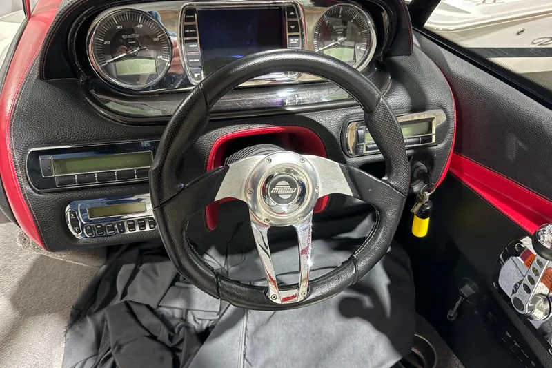 Slide: The Image of Dashboard of a 2009 Malibu Wakesetter 23 LSV boat with steering wheel and gauges. - 9