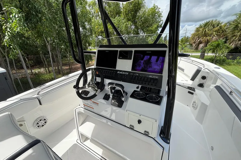 Slide: The Image of 2020 Blackfin 252 CC boat cockpit with modern controls and navigation system. - 12