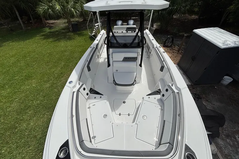 Slide: The Image of 2020 Blackfin 252 CC boat, top view, sleek design, spacious deck, surrounded by greenery. - 15