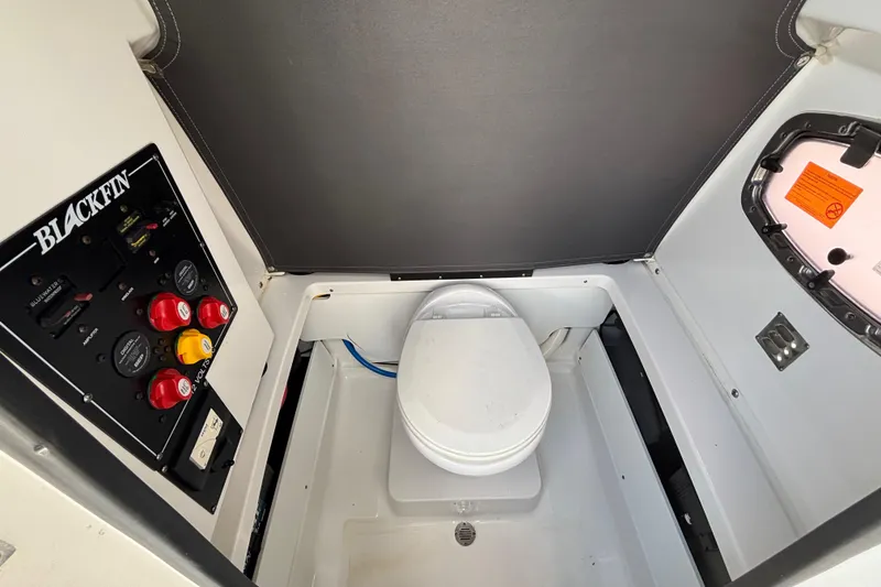 Slide: The Image of 2020 Blackfin 252 CC boat interior with control panel and marine toilet. - 18