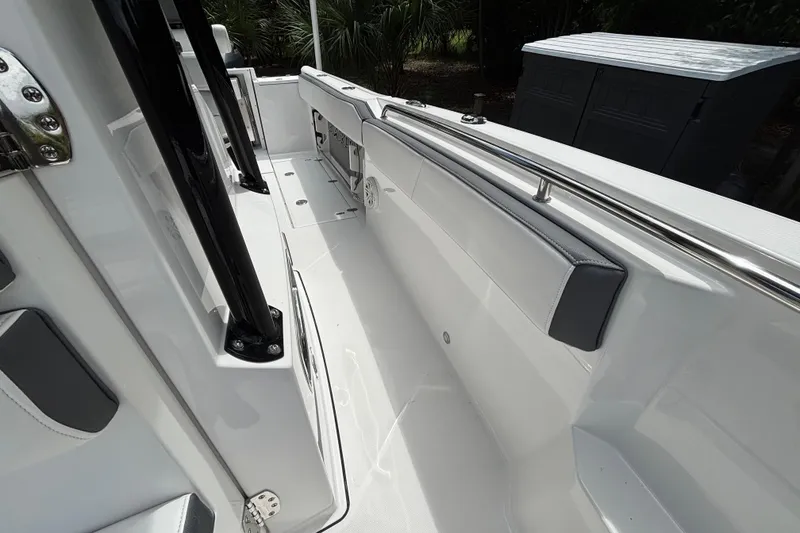 Slide: The Image of 2020 Blackfin 252 CC boat interior with sleek white design and stainless steel railings. - 19