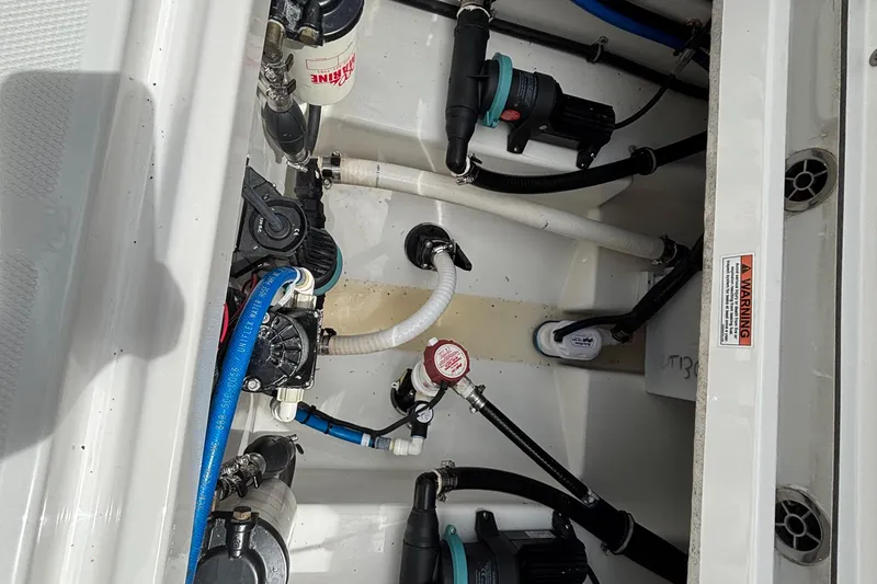Slide: The Image of 2020 Blackfin 252 CC boat plumbing system with hoses and pumps. - 26