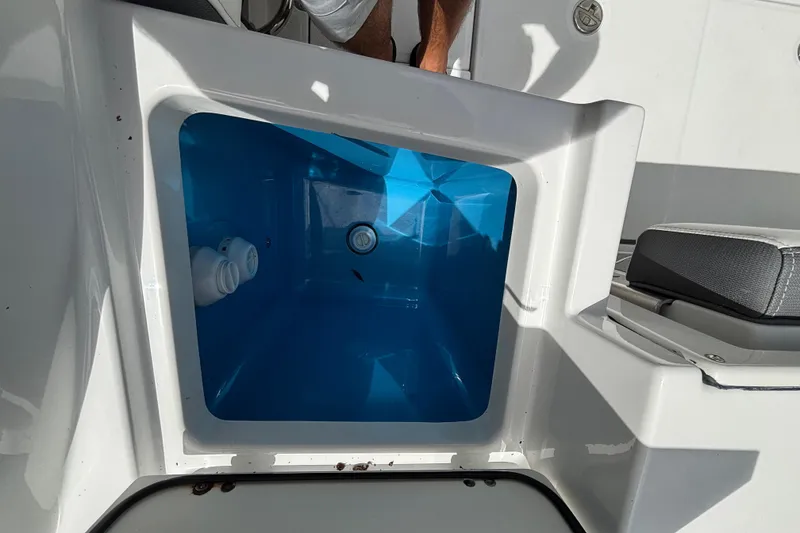 Slide: The Image of Livewell compartment on a 2020 Blackfin 252 CC boat, featuring a blue interior. - 28