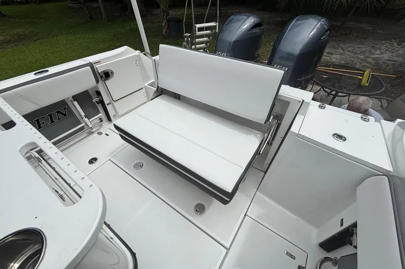 Slide: The Image of 2020 Blackfin 252 CC boat interior with white seating and dual outboard motors. - 29