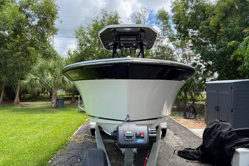 Slide: The Image of 2020 Blackfin 252 CC boat on trailer, surrounded by lush greenery. - 3