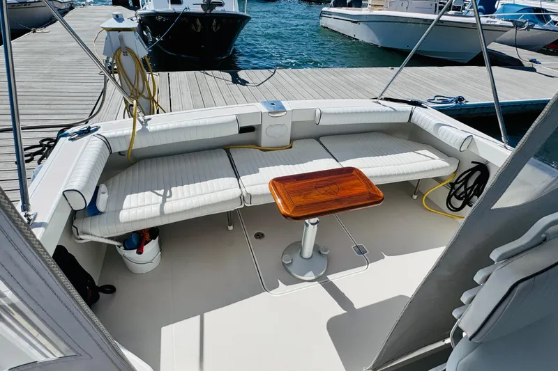 Slide: The Image of 2007 Back Cove 29 boat interior with seating and wooden table at dock. - 17