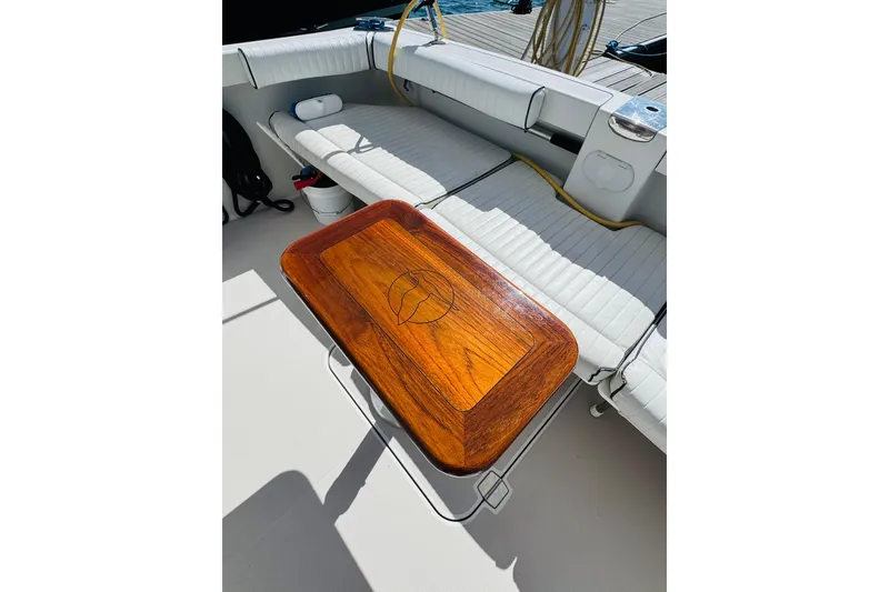 Slide: The Image of Luxurious 2007 Back Cove 29 boat interior with elegant wooden table and cushioned seating. - 18